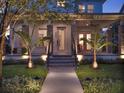 Close up of a charming front porch with stylish stone columns, and manicured landscaping at 8665 Pinter St, Orlando, FL 32827
