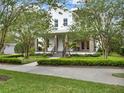 Beautiful two-story home with a cozy front porch, stylish stone columns, and lush landscaping at 8665 Pinter St, Orlando, FL 32827