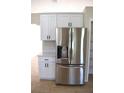 Modern kitchen with stainless steel fridge and sleek white cabinets at 910 Amy Ridge Ct, Kissimmee, FL 34747