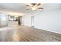 Open concept living room featuring luxury vinyl plank flooring, eat-in kitchen, and modern ceiling fan at 9376 Se 175Th Pompion St, The Villages, FL 32162