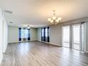 Spacious and bright living room features modern ceiling fan, luxury vinyl plank flooring, and double glass doors at 9376 Se 175Th Pompion St, The Villages, FL 32162