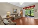 Comfortable living room featuring hardwood floors, a screen door to the screened in patio, and lots of light at 9440 Myrtle Creek Ln # 1003, Orlando, FL 32832