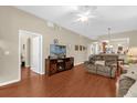 Inviting living room with wood floors, ceiling fan, and comfortable seating at 9440 Myrtle Creek Ln # 1003, Orlando, FL 32832