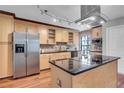 Updated kitchen features stainless steel appliances, wood cabinets, and granite countertops at 995 Troon Trce, Winter Springs, FL 32708