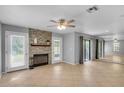 Living room with neutral paint, fireplace with stone accent wall, and tile flooring at 995 Troon Trce, Winter Springs, FL 32708