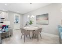 Bright dining area featuring a modern round table, stylish chairs, and contemporary decor at 10009 Randal Walk St, Orlando, FL 32832