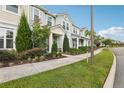 Street view of townhomes with lush landscaping, sidewalks, and a welcoming community vibe at 10009 Randal Walk St, Orlando, FL 32832
