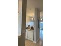 This kitchen features white cabinets, a chandelier, and views to the backyard at 10604 Savannah Wood Dr # 84, Orlando, FL 32832