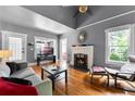 Cozy living room featuring hardwood floors, fireplace, and natural light at 110 N Brown Ave, Orlando, FL 32801