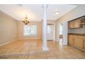 Charming dining room featuring tile floors, a modern chandelier, and a convenient wet bar at 13524 Lake Luntz Dr, Winter Garden, FL 34787
