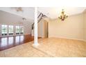 Inviting living room featuring beautiful tile and hardwood floors, a ceiling fan, and staircase access at 13524 Lake Luntz Dr, Winter Garden, FL 34787