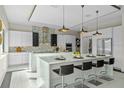 Stylish kitchen showcases an expansive marble island with seating, modern cabinetry, and stainless steel appliances at 14124 Eliot Ave, Orlando, FL 32827