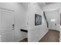 Bright foyer featuring wainscoting, a built-in desk, and staircase at 14193 Gold Bridge Dr, Orlando, FL 32824