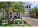Charming two-story home boasting a brick driveway and a beautifully landscaped front yard at 14193 Gold Bridge Dr, Orlando, FL 32824