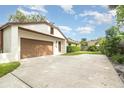 Wide driveway leads to a two-car garage, offering ample parking space and enhancing the property's accessibility at 1424 Mt Laurel Dr, Winter Springs, FL 32708