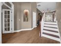 Elegant entryway showcasing hardwood floors, staircase and decorative niche at 1462 Palm Bay Ct, Lake Mary, FL 32746