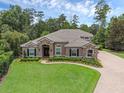 Stunning single-story home with lush landscaping and a paver driveway at 1462 Palm Bay Ct, Lake Mary, FL 32746