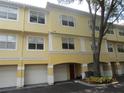 Inviting exterior view of a multi-story townhome with garage access and a well-maintained facade at 1960 Legacy Cove Dr, Maitland, FL 32751