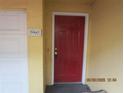 Close-up of the red front door with a unit number next to the drive-in garage at 1960 Legacy Cove Dr, Maitland, FL 32751
