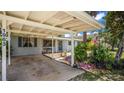 Charming carport area with lush landscaping framing this inviting single Gathering home's front at 1963 Forest Ave, Daytona Beach, FL 32119