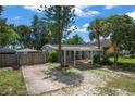 Inviting single-story home featuring a carport, landscaped front yard, and welcoming entryway at 1963 Forest Ave, Daytona Beach, FL 32119