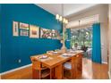 Dining room with stylish decor, wood floors, and sliding glass doors to the outdoor pool area at 219 Isle Of Sky Cir, Orlando, FL 32828