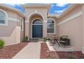 Inviting entryway with double doors, accent windows, and a cozy seating area at 219 Isle Of Sky Cir, Orlando, FL 32828