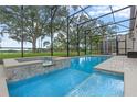 Relaxing screened pool with an integrated hot tub, perfect for entertaining or unwinding at 219 Isle Of Sky Cir, Orlando, FL 32828