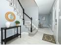 Bright entryway with a staircase and views into the living spaces at 2304 Harding Cir, Deltona, FL 32738