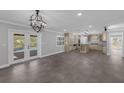 Open-concept layout featuring luxury vinyl plank flooring, modern lighting, and access to the backyard pool at 2630 S Tanner Rd, Orlando, FL 32820
