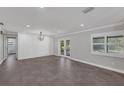 Bright living area with French doors, luxury vinyl plank flooring, and modern lighting at 2630 S Tanner Rd, Orlando, FL 32820