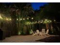 The backyard features beautiful string lights, attractive pavers, and lush landscaping at 3601 S Summerlin Ave, Orlando, FL 32806