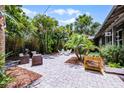 A tropical backyard features attractive stone pavers and luxurious greenery at 3601 S Summerlin Ave, Orlando, FL 32806