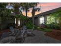 Cozy backyard patio with seating, palm trees, and string lights at 3601 S Summerlin Ave, Orlando, FL 32806