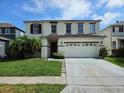 Inviting two-story home featuring a classic design and well-maintained front yard at 438 Janice Kay Pl, Kissimmee, FL 34744