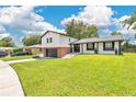 Charming two-story home with a brick and gray two-car garage and beautifully manicured lawn at 614 Mockingbird Ln, Altamonte Springs, FL 32714
