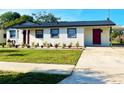 Charming home featuring a well-manicured lawn and fresh landscaping at 6366 Forecastle Ct, Orlando, FL 32807