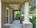 Inviting front porch showing the stone and stucco pillars, offering an outdoor relaxation space at 6971 Tettenhall Ln, Windermere, FL 34786