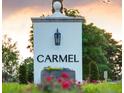 Elegant community entrance sign with lush landscaping and a welcoming atmosphere at 7011 Via Carmel Way, Orlando, FL 32819