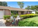 Attractive home exterior featuring well-maintained shrubs, green lawn, and charming front yard decor at 7022 Talbot Dr, Orlando, FL 32819
