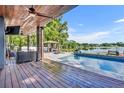 Expansive outdoor patio with views of the pool, outdoor kitchen and lake at 7801 Georgeann St, Winter Park, FL 32792