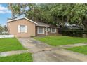 Exterior view showcasing a well-maintained lawn, classic architecture, and inviting curb appeal at 8111 Esperanza St, Orlando, FL 32817
