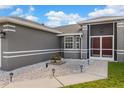 Close up of the home's entrance, with a decorative rock garden, and charming front doors at 906 Highland Crest Cir, Lake Wales, FL 33853