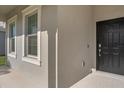 Inviting entrance with a classic black front door and neutral-toned exterior at 9535 Beautiful Way, Winter Garden, FL 34787