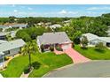 Beautiful aerial view of a well-maintained home with lush landscaping in a peaceful neighborhood, offering serene living at 956 Chula Ct, Lady Lake, FL 32159