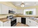 Functional kitchen featuring white cabinetry, modern appliances, and ample counter space for culinary enthusiasts at 956 Chula Ct, Lady Lake, FL 32159