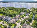 An aerial view of a luxury home in a neighborhood on a lake at 10319 Lavande Dr, Orlando, FL 32836