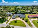 Expansive property featuring a well-maintained lawn, brick driveway, and a charming single-story home at 105 John Anderson Dr, Ormond Beach, FL 32176