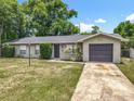 Attractive single-story home with a neat lawn and a convenient attached single car garage at 117 Burns Ave, Longwood, FL 32750