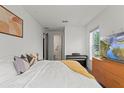 Bright bedroom with a comfortable bed, piano, and a scenic view from the window at 12468 Koshiba Aly, Orlando, FL 32827